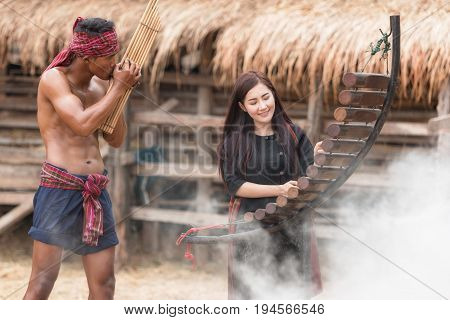 Asian beautiful girl are happy playing Pong Lang is a Thai musical instrument in summer at Countryside.