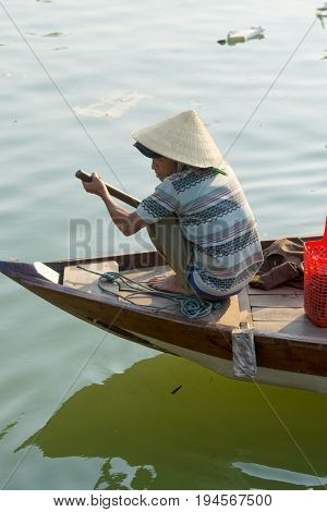 Hoi An Vietnam - February 20 2017 - The boatwoman  on the old national vietnamese boat down the Thu Bong river.