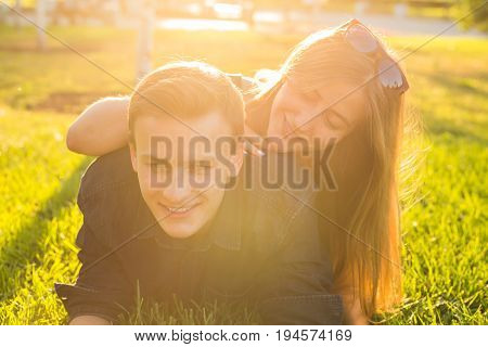 Beautiful young happy couple having fun in the grass