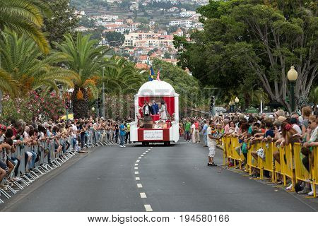 FUNCHAL MADEIRA PORTUGAL - SEPTEMBER 4 2016: Men in historical fashion dress raise toasts durnig historical and ethnographic parade of Madeira Wine Festival in Funchal. Madeira Portugal
