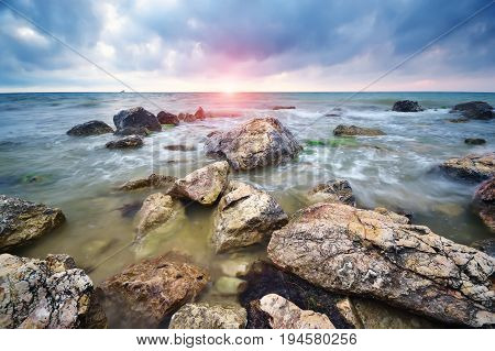 Beautiful seascape. Stones on sea shore. Nature composition.