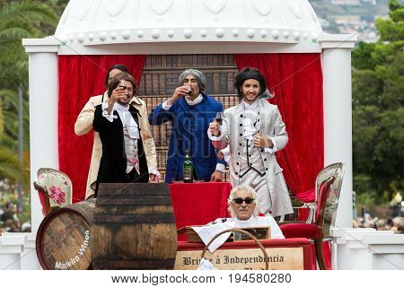 FUNCHAL MADEIRA PORTUGAL - SEPTEMBER 4 2016: Men in historical fashion dress raise toasts durnig historical and ethnographic parade of Madeira Wine Festival in Funchal. Madeira Portugal