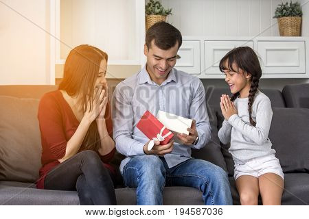 Little Girl Give A Present To Dady At Home With Happy Emotion Happy Family Concept.