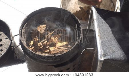 Open and smoke bee smoker. Cllose up top view images.