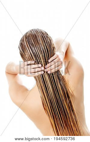 Photo of woman applying hair conditioner.