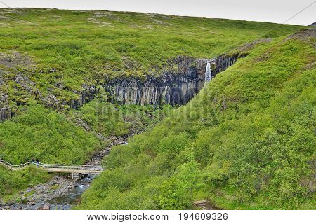 Famous Icelandic Svartifoss waterfall in the basalt (whinstone) canyon placed in Vatnajökull National Park in the eastern Iceland
