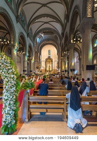Manila Philippines - 6 March 2016. Public worship in the historic cathedral church in Manila Philippines. Church of St. Augustine is the main church of capital Manila Philippines