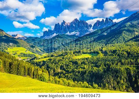 Warm autumn in  the Val de Funes, Dolomites. The concept of ecological tourism. The valley in Tirol is surrounded by a dentate wall of dolomite rocks