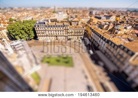 Aerial cityscape view on the old town of Bordeaux city during the sunny day in France. Tilt-shift image technic