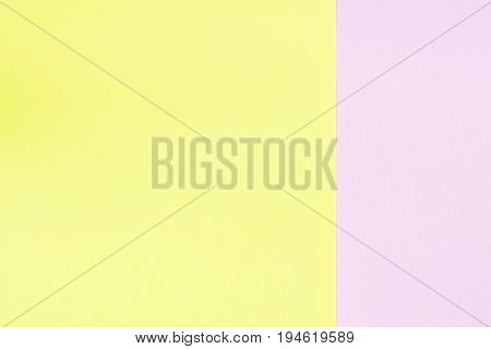 pink and yellow paper background. Which is pastel / Divide the pink into one of three parts of the picture. And yellow is two-thirds of the image / gap area for copy space.