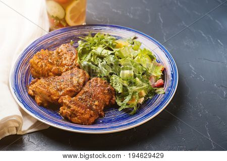 Platter Of Chicken Thighs Piri Piri Coated In Hot Sauce With Salad.