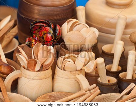 Wooden kitchen utensils: cups and spoons. Kitchen Decor.