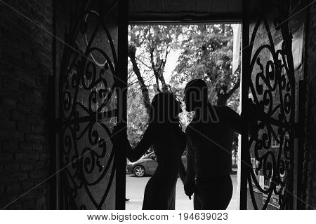 Young, Beautiful Bride And Groom Walking Along The Street In The City