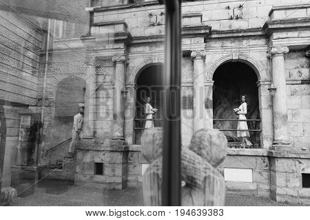 Young, Beautiful Bride And Groom Walking Along The Street In The City