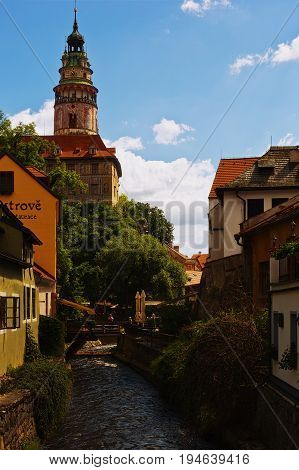 CESKY KRUMLOV CZECH REPUBLIC - JULY 06 2016: Castle tower stands over the Vltava confluent