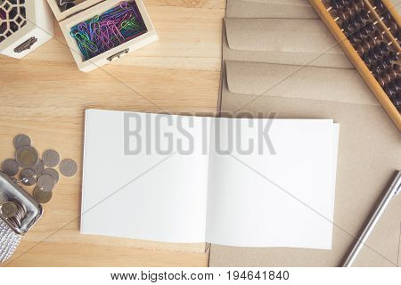 abacus notebook paper pen money and wood box on business desk