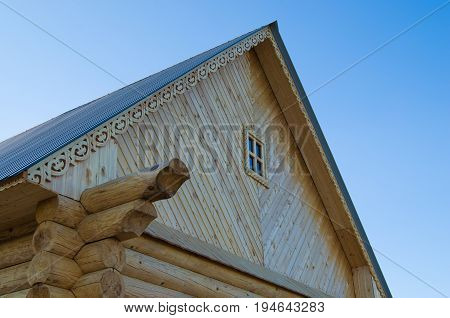 The roof of wooden house on volna blue sky
