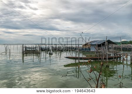 Homestay and floating basket in lake at Kohyo Songkhla Thailand with beautiful sky and clouds. This is traditional fisheries area.