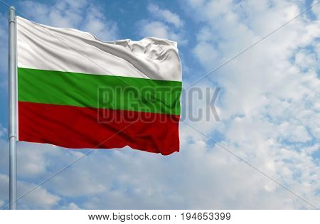National flag of Bulgaria on a flagpole in front of blue sky