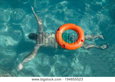 Lifebuoy and lifeguard in action under water