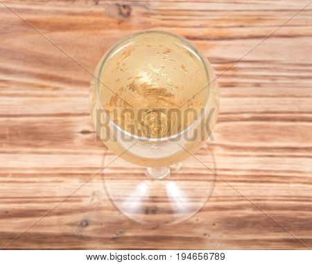 Glass of white wine on vintage wooden background