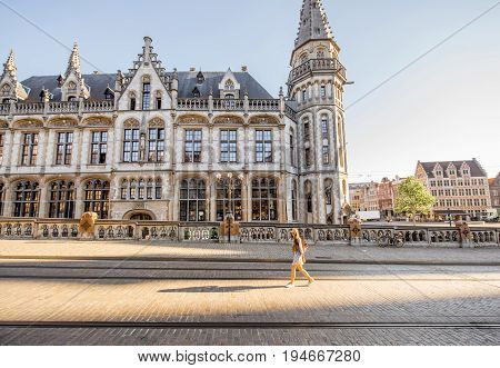 Stret view on the Post office building with woman walking during the morning in Gent city, Belgium