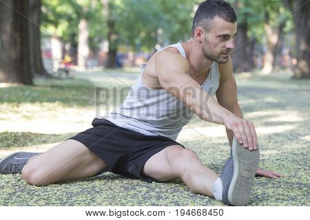 Young Athlete Doing Stretching Exercises In The Park