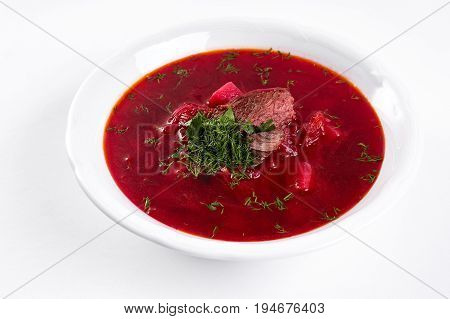 ukrainian soup borsch on white plate. Traditional ukrainian dish borsch isolated on white table. first course