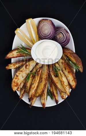 Baked Potatoes And Red Lus With Rosemary, Lemon And Aioli Sauce On A White Plate..