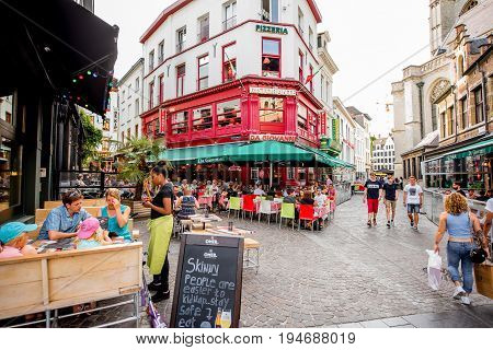 ANTWERPEN, BELGIUM - June 02, 2017: Street view with crowded cafes and restaurants at the center of the old town of Antwerpen city in Belgium