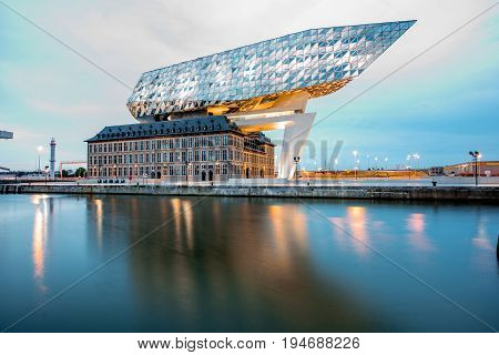 ANTWERPEN, BELGIUM - June 02, 2017: Night view on the illuminated Port House building designed by Zaha Hadid architect in 2009 in Antwerpen city, Belgium
