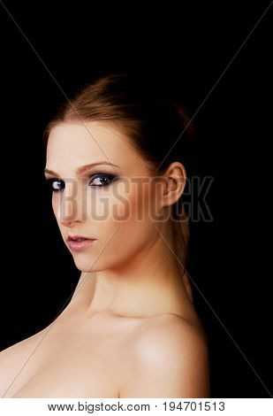 Attractive blonde topless woman with dark make up