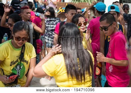 BORACAY, WESTERN VISAYAS, PHILIPPINES - JANUARY 11, 2015: Boys and girls dancing with yellow and pink shirts during Ati-Atihan Festival at White Beach.