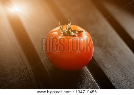 Tomato isolated on black wood backgroound. Lifestyle healthy eating Food photo concept