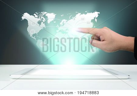 Businessman working send a global business team is using modern technology hologram of the World map on the tablet. omni channel icon flow.