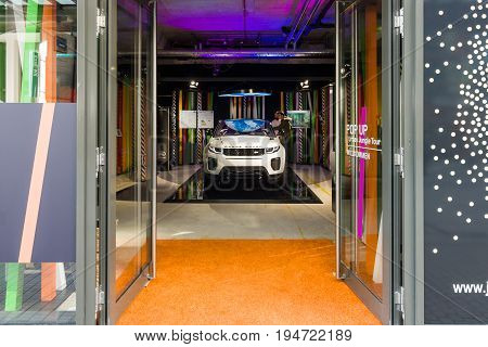 STUTTGART GERMANY - MARCH 18 2016: Land Rover showroom and a car Range Rover Evoque. Historical Street Calwer Strasse in the city center. Stuttgart is the capital and largest city of the state of Baden-Wuerttemberg.