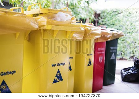 Garbage trash bins, separate wet, danger, dry and recycle waste, selective focus shallow depth of field