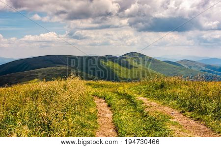 beautiful summer landscape in mountains. fine weather with blue sky and some clouds. gorgeous travel background with footpath through the mountain ridge