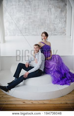 pregnant woman and man posing together in Studio, happy waiting