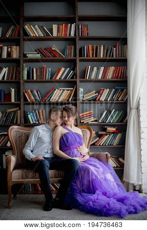 pregnant woman and man posing together in Studio, happy waiting