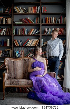 pregnant woman and man posing together in Studio, happy waiting