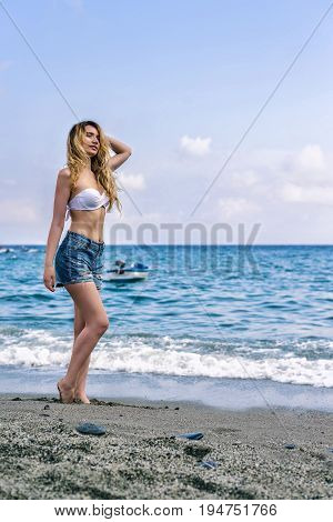 Girl at the beach in Monterosso al Mare Italian riviera. Sea and mountain view. Cinqueterre Liguria beauty