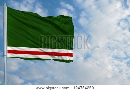 National flag of Chechen Republic of Ichkeria on a flagpole in front of blue sky.