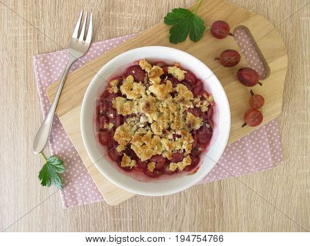 Homemade gooseberry crumble - Gooseberries topped with crumble from of butter, flour, rolled oats and sugar