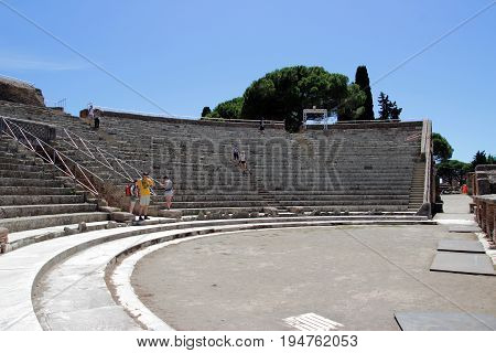 OSTIA ANTCA ITALY - JULY 2 2017: People in the Ancient Roman TheaterOstia town was built on both the sea and the Tiber river near Rome this special position determined its relevance since the 620 BCE