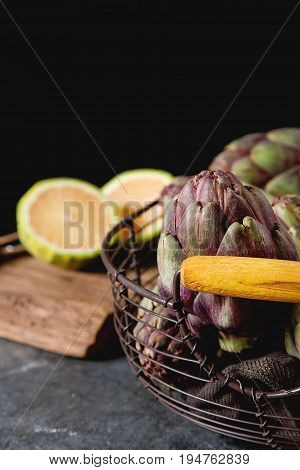 Baby Ripping Organic Artichokes With Lemon. Food For A Vegan And