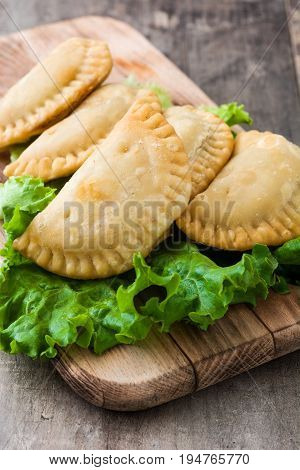 Delicious typical Spanish empanadas on wooden table