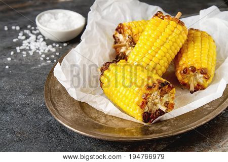 Corn Grilled With Salt And Spices. Dark Background. Fast Food In