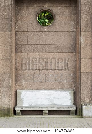 Ancient stone bench with painted backrest near the big brick wall