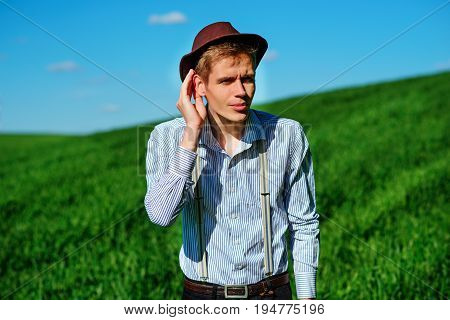 Handsome Man In The Nature Tries To Hear Something With Putting His Hand To His Ears